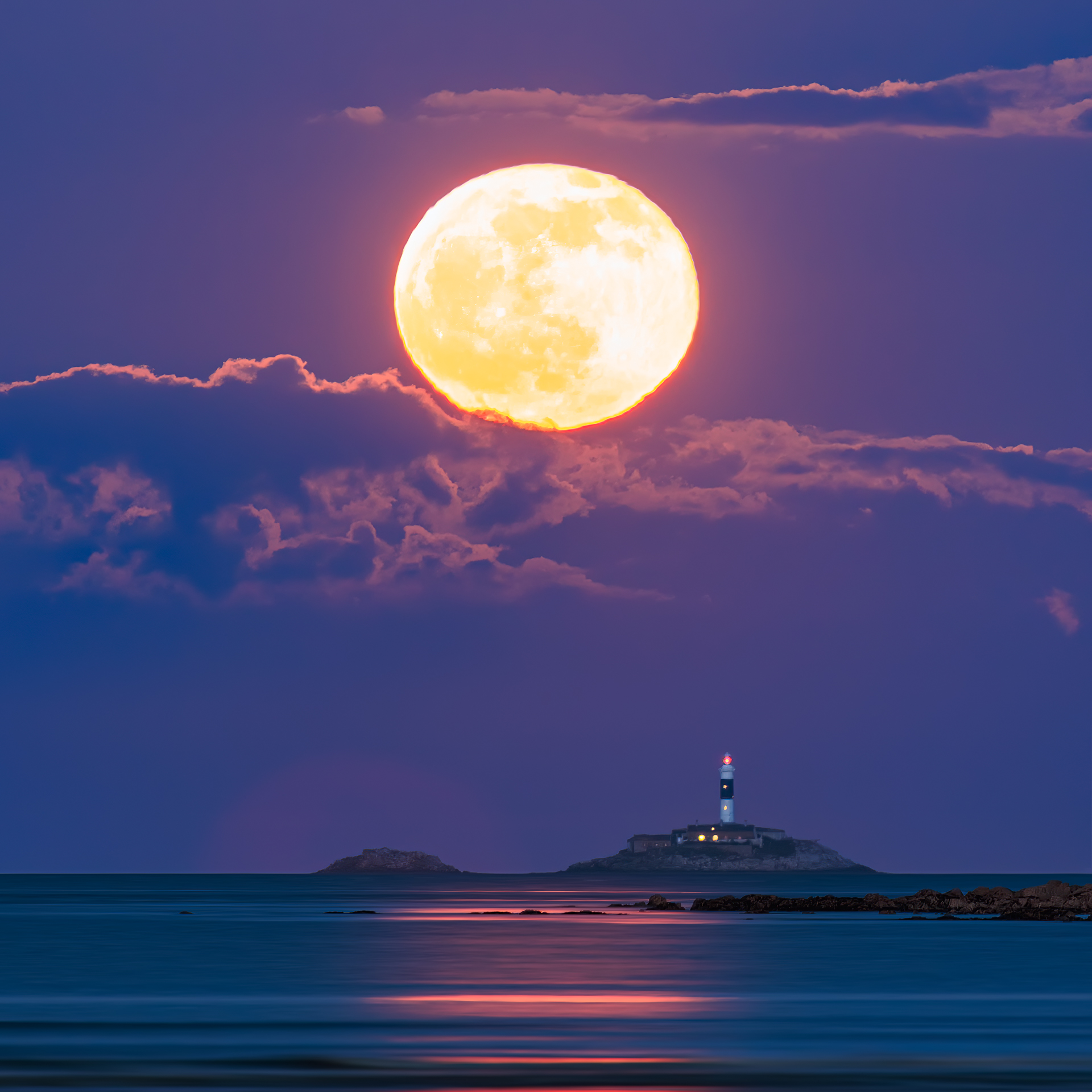 Full Moon rising above Rockabill Island and Lighthouse, moonlight glimmering in the Irish Sea.
